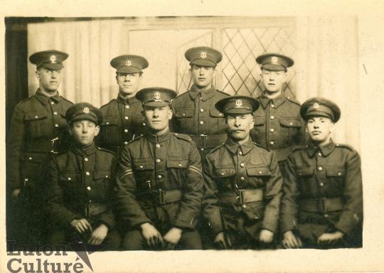 Group photograph of eight soldiers including Ronald Rootham